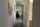 Hallway with neutral walls, white doors, and string wall art