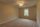 Empty carpeted room with ceiling fan
