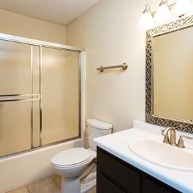 Image of a bathroom with a sink, toilet, and shower